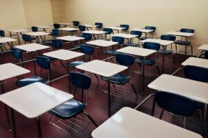 pexels-photo-256395-256395 An indoor view of a modern, clean classroom with rows of empty desks and chairs.
